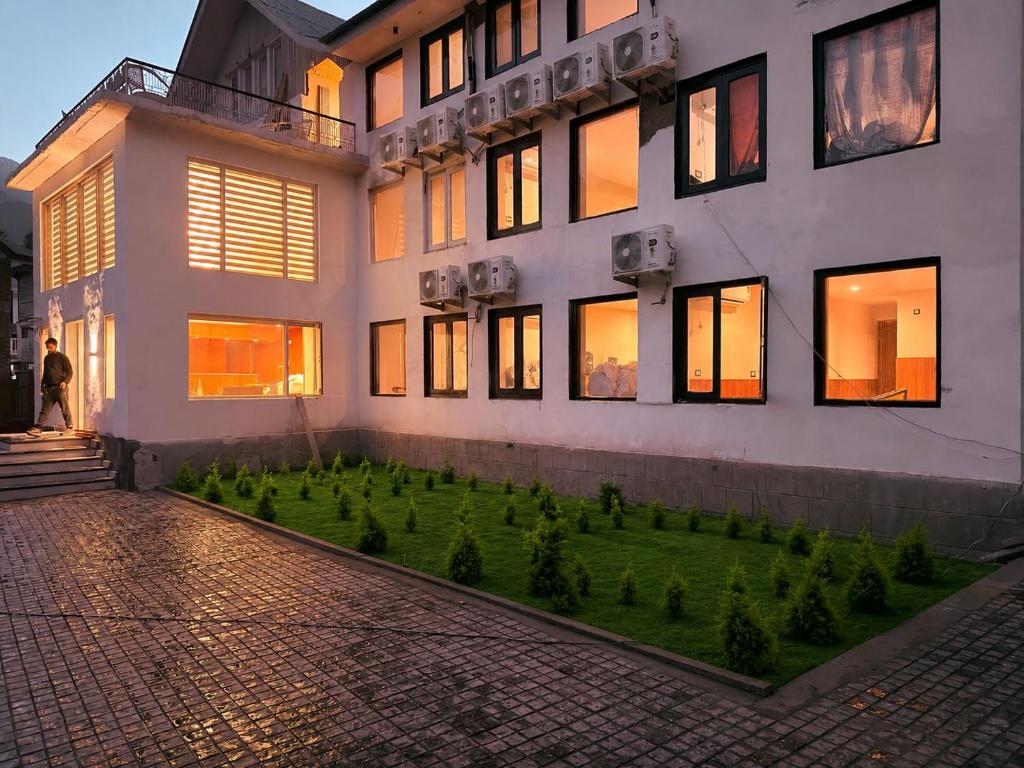 a building with a garden in front of it at The Countryside Resorts Pahalgam in Pahalgām