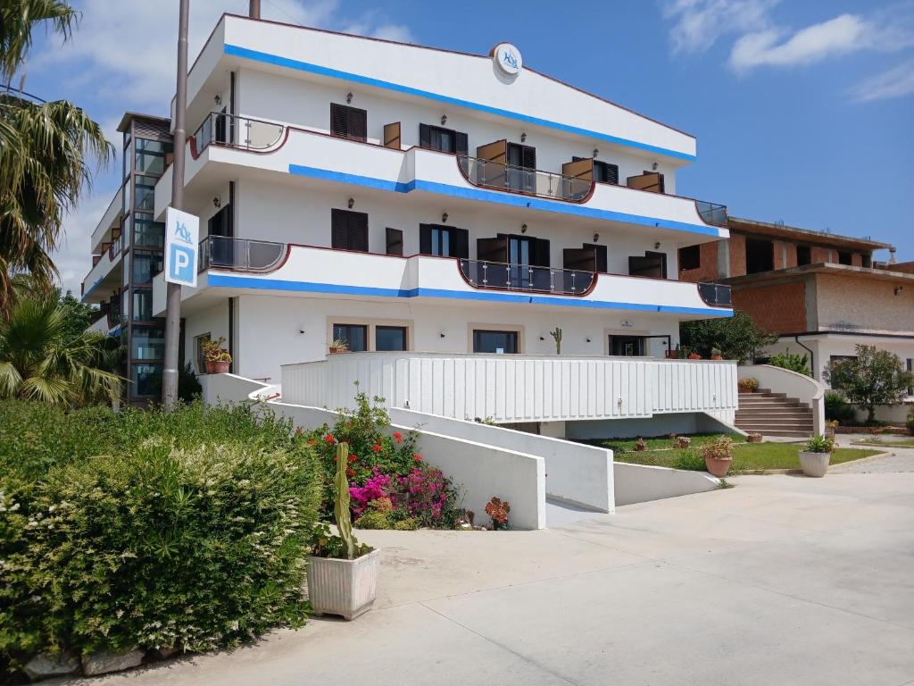 ein großes weißes Gebäude mit Balkonen in der Unterkunft Hotel Onda Bleu in Botricello