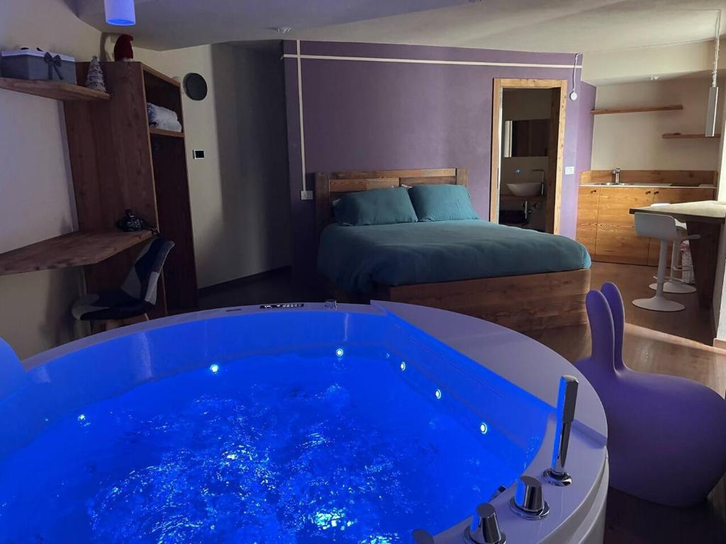 a room with a blue tub in a bedroom at Lo Berio Morgex in Morgex