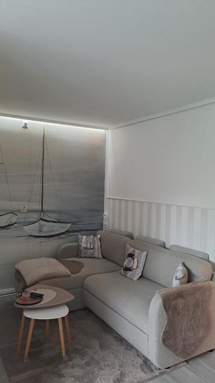 a living room with a couch and a table at Saltwater Hohwacht in Hohwacht