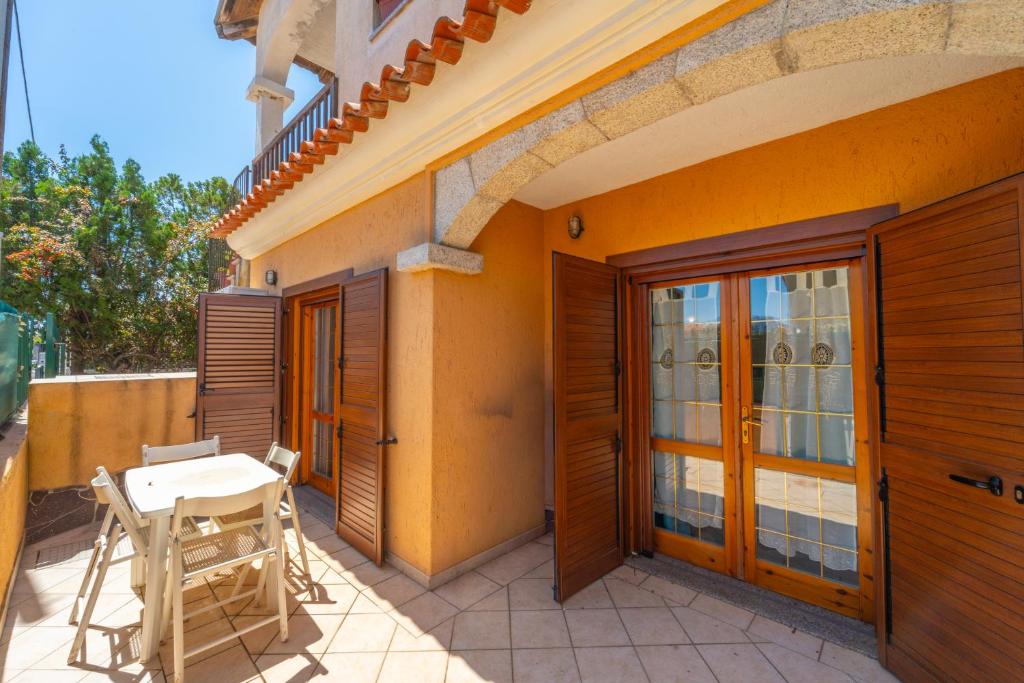 a patio with a table and chairs next to a building at Raffy by DomusAway in Porto San Paolo