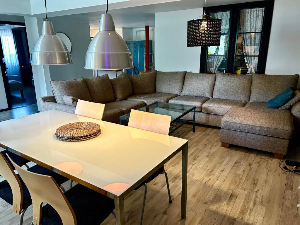 a living room with a couch and a table at Halek Hem - Haga loft in Enånger