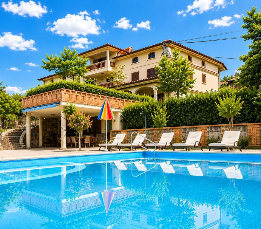 a villa with a swimming pool in front of a house at Villa Nona with swimming pool in Dornberk