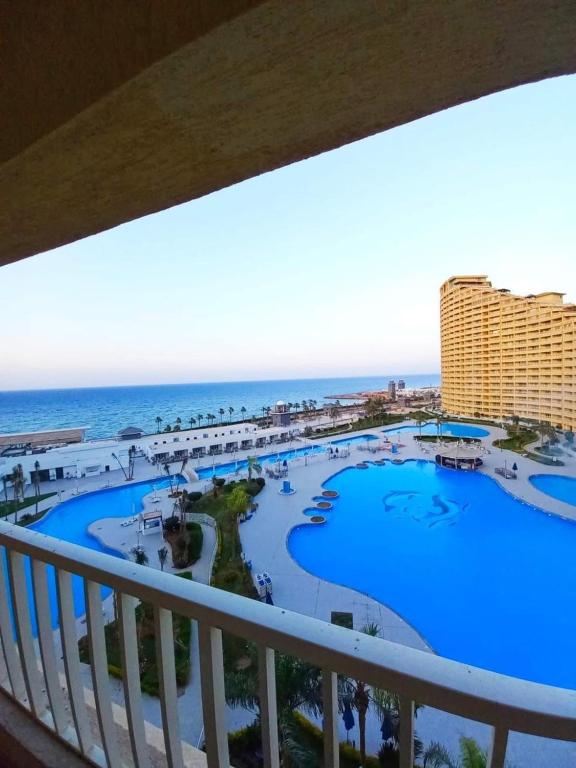 a view from the balcony of a resort with a pool at اهرمات بورتو السخنه in Madinaty