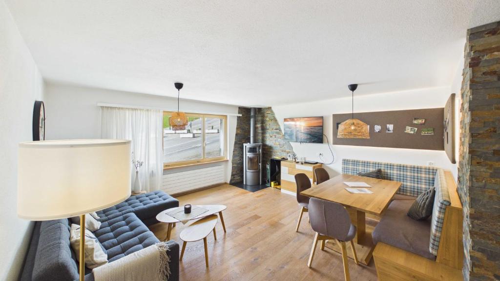 a living room with a couch and a table at Casa Terza - CharmingStay in Flumserberg