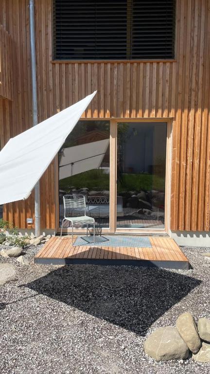 a building with a patio with a chair and a tent at Refugium in Schwaigen