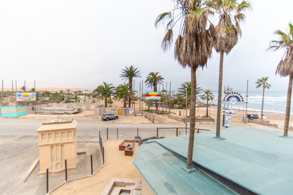 a view of a beach with palm trees and a skate park at Beach View Apartment 205 in Swakopmund