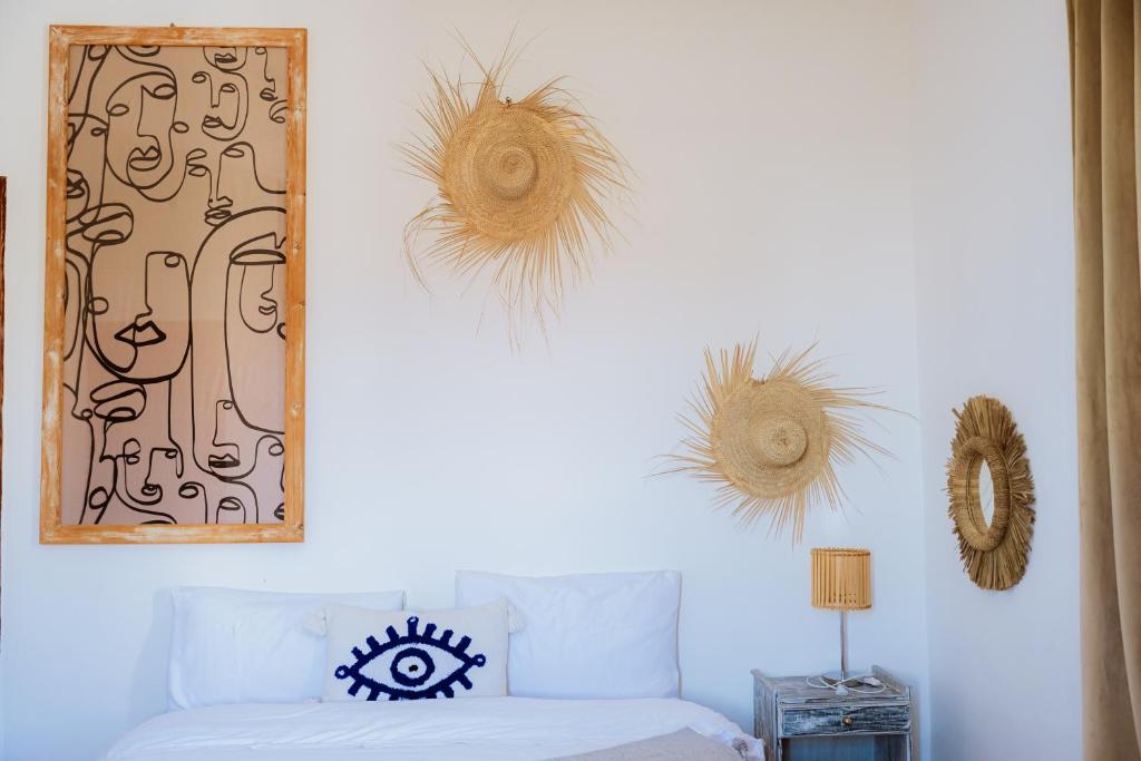 a living room with a white couch and hats on the wall at Salty in Essaouira