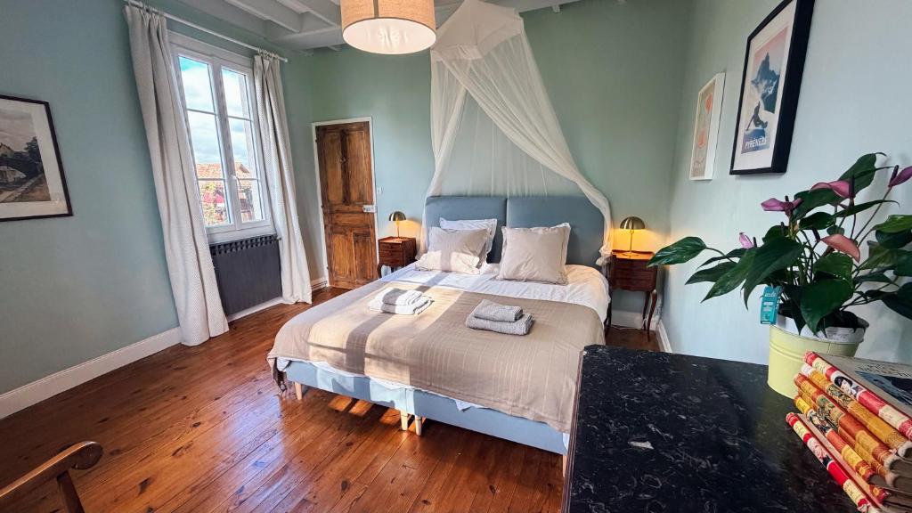 a bedroom with a bed with a blue headboard at Au moulin d'Izaourt in Izaourt