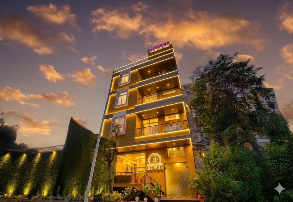 a tall building with lights on top of it at Hotel The Hidden Door-Near Jaipur Airport in Jaipur
