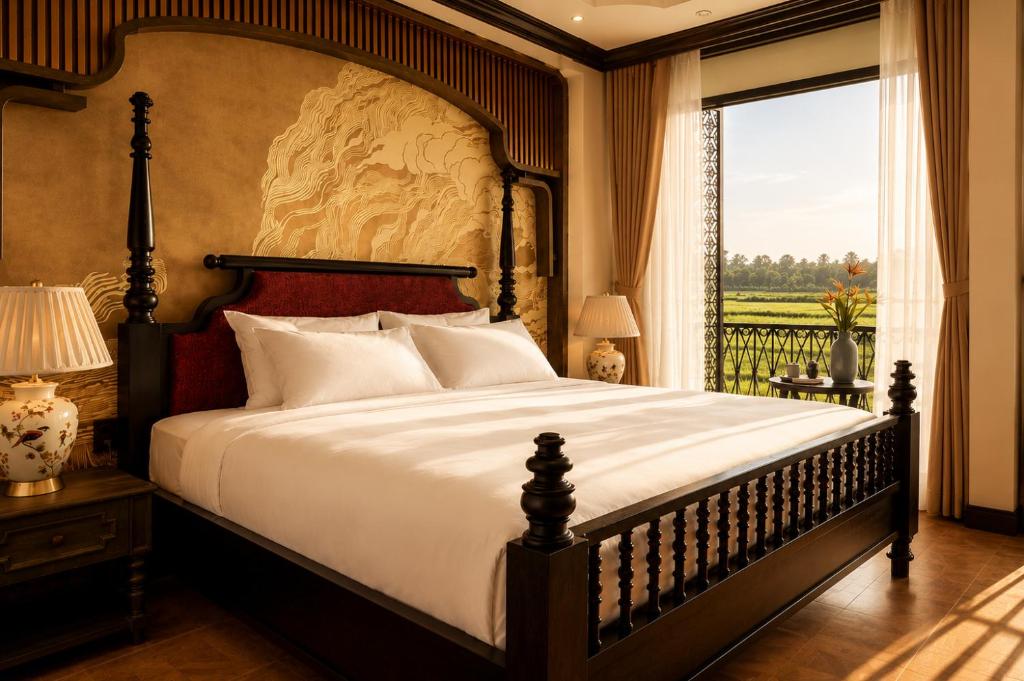 a bedroom with a large bed with a large window at Cao Boutique Hotel in Thôn Trường Giang