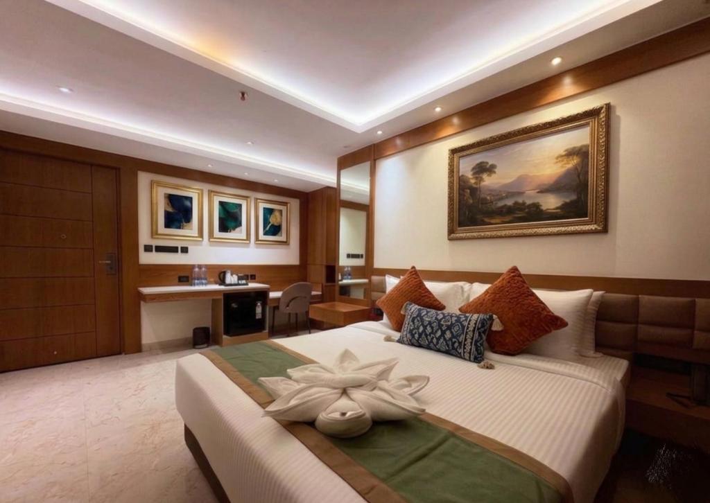 a bedroom with a large bed with a flower on it at Hotel Green View in Baharampur
