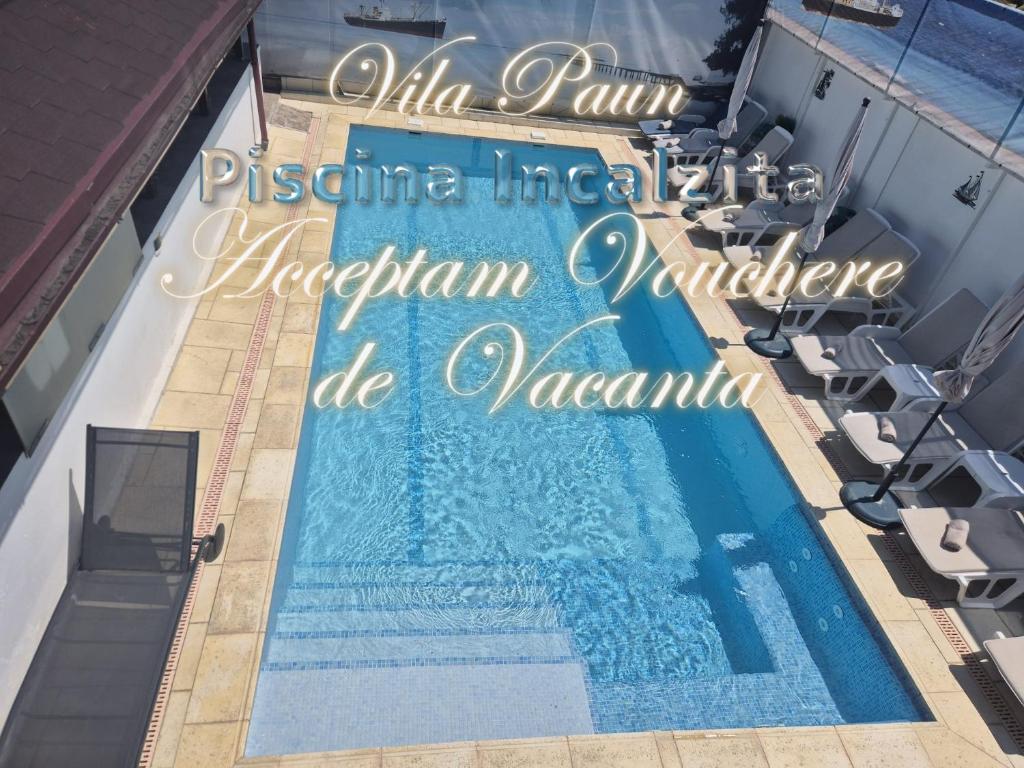 an overhead view of a swimming pool with the words villa indira mandir at Vila Paun in Costinesti