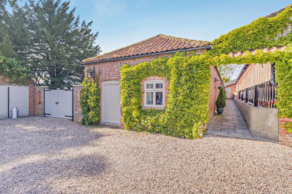 a brick house with ivy on the side of it at 1 Bed in Market Rasen oc-73852 in East Barkwith