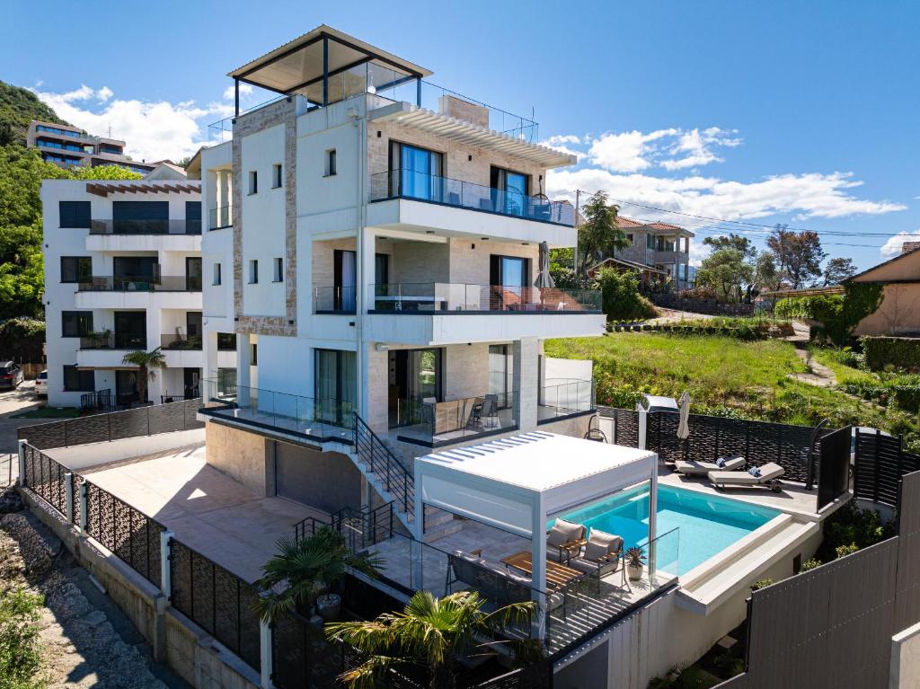 a building with a swimming pool next to a building at Villa Aquilla in Tivat