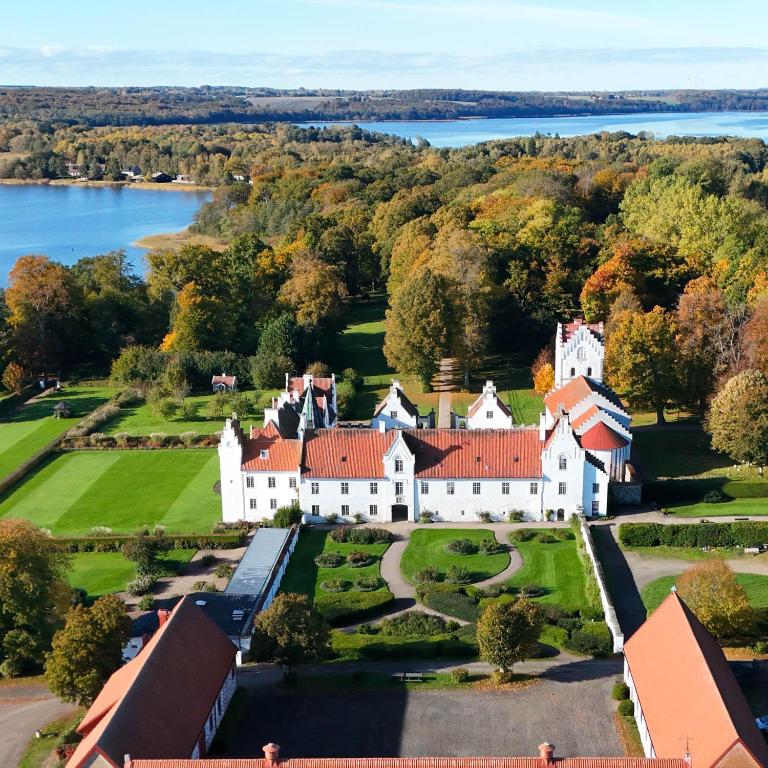 an aerial view of a large white house with red roof at Guest apartment in the castle in Höör
