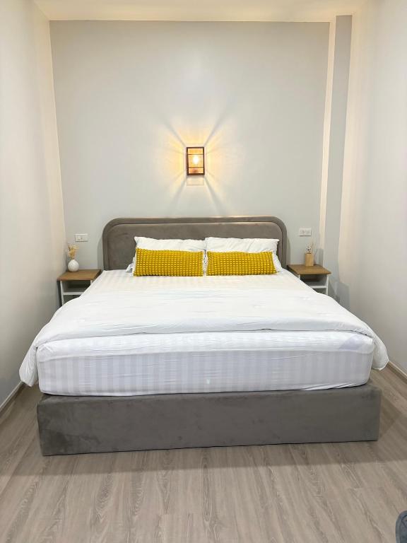 a bedroom with a large bed with yellow pillows at Pomt Lagoon in Ban Khlong Dan