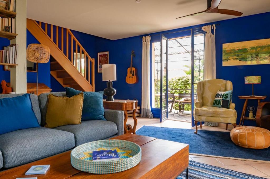 a blue living room with a couch and a table at La Maison Bleue in Rustrel