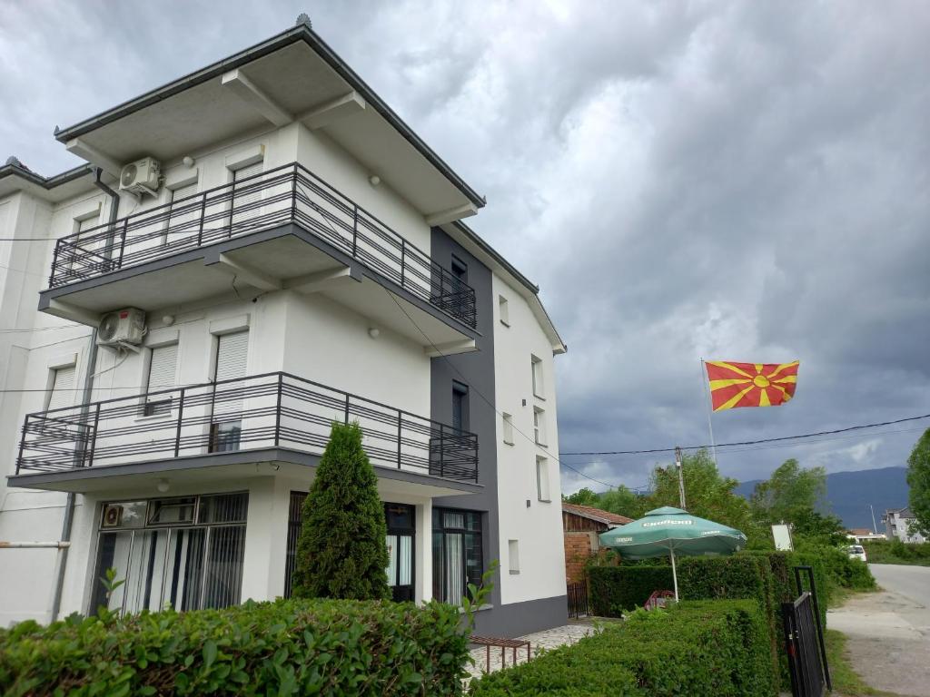 a white house with a kite in front of it at Ambient Apartments in Struga