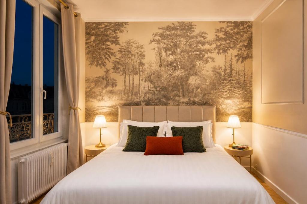 a bedroom with a large white bed with a red pillow at Haussmannien calme hyper-centre in Troyes