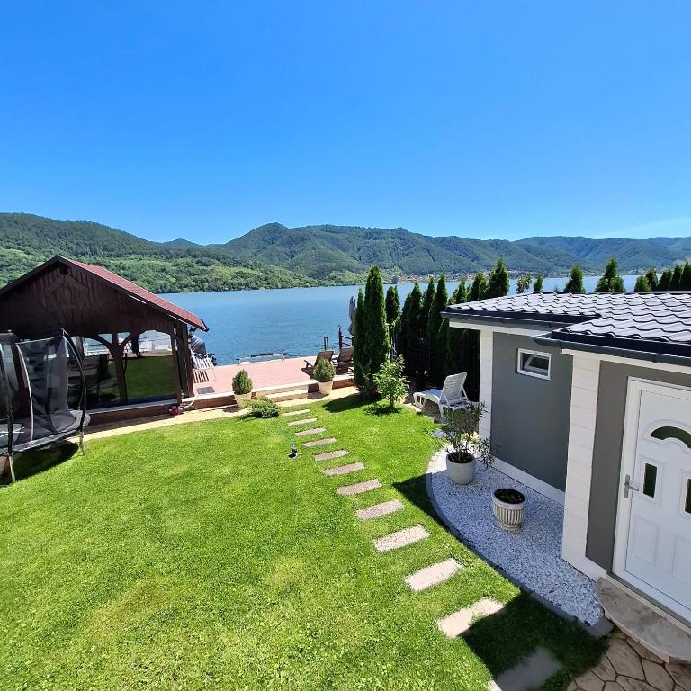 a backyard with a view of the water at Casa Dorin in Orşova