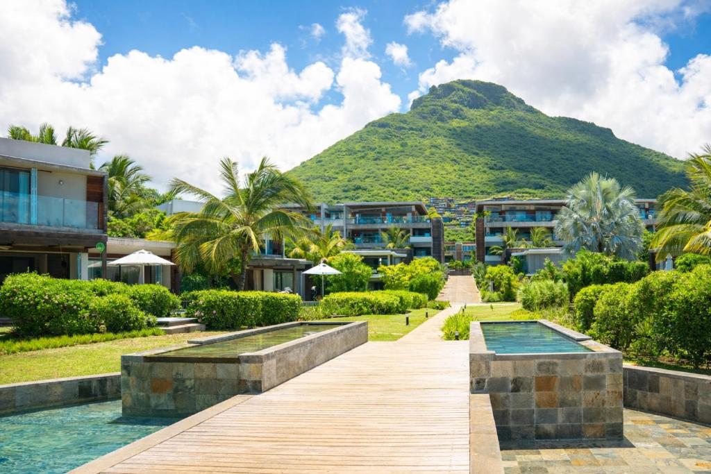 a resort with a mountain in the background at Manta Cove by Blue Zebra Holidays in Rivière Noire