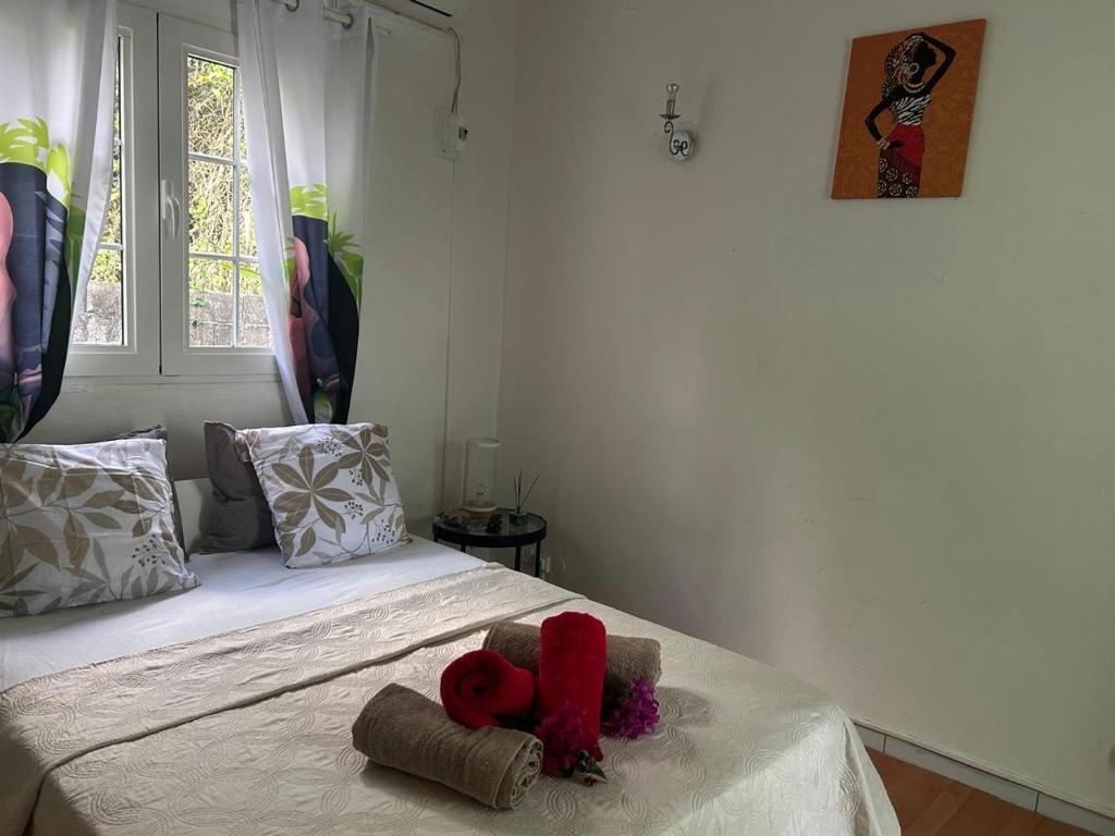 a bedroom with a bed with two stuffed animals on it at Le cocon de Coco in Lamentin
