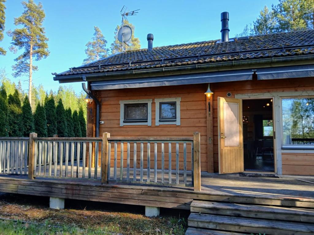 a wooden house with a porch and a door at Villa Polly, Jaala, Luxury cottage with private sauna in Kouvola