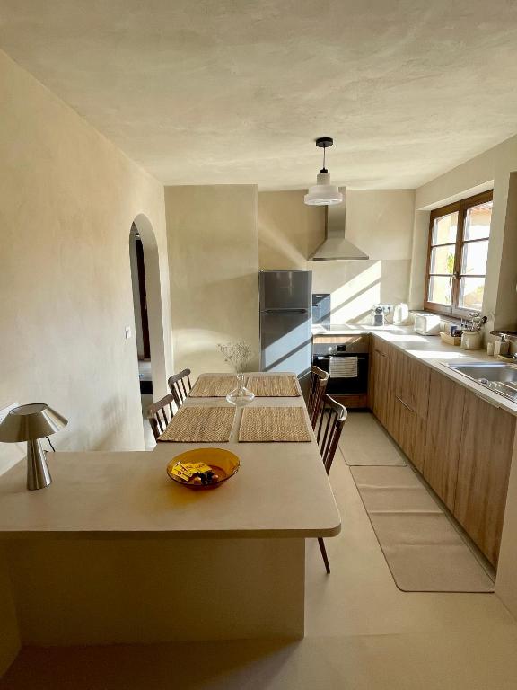 a kitchen with a table with a bowl on it at Maison Maragelie in Westhoffen