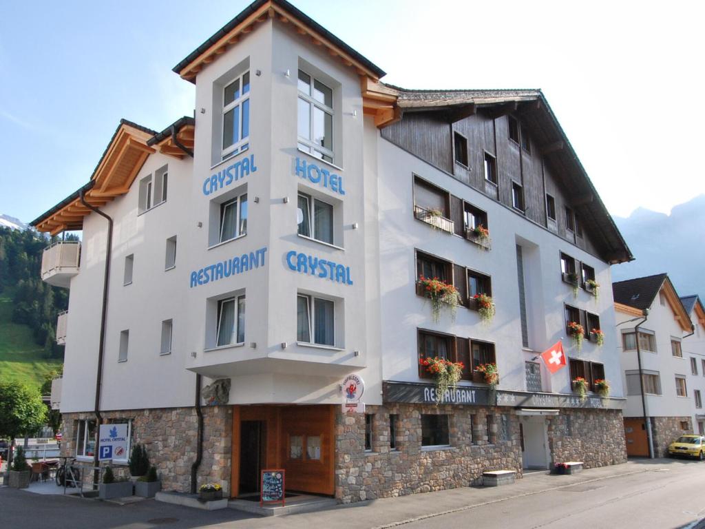 a white building with blue writing on it at Hotel Crystal in Engelberg