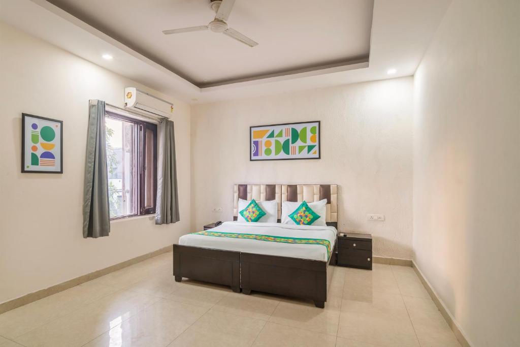 a bedroom with a bed and a window at Treebo Modern Stays in Noida