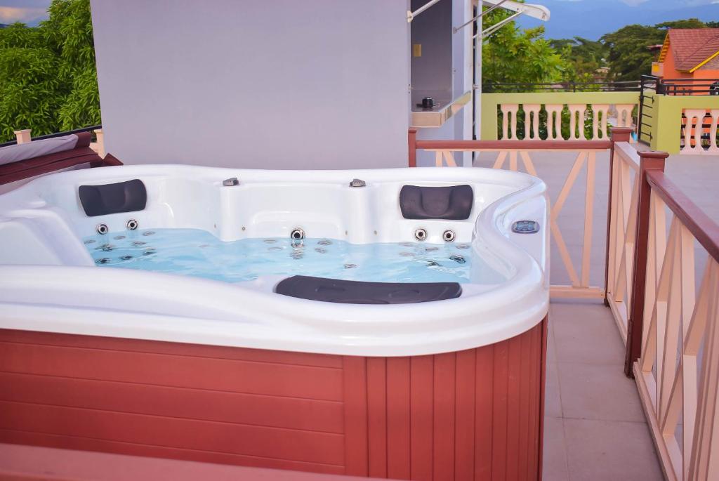 a bath tub sitting on top of a balcony at Cedar Grove Luxe in Portmore