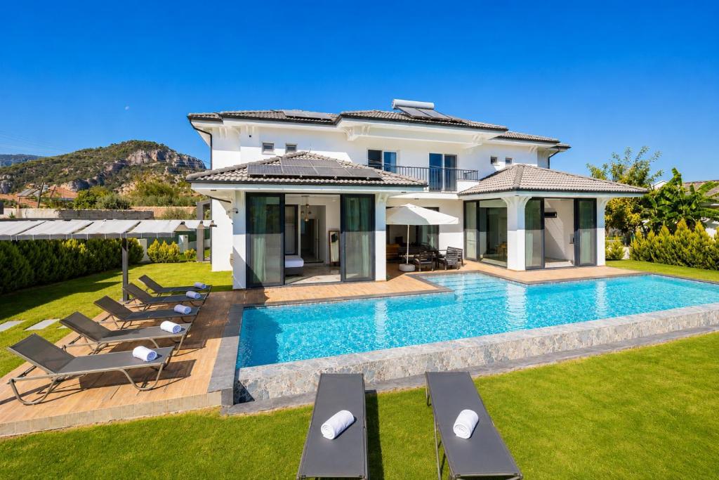 a villa with a swimming pool and lawn at Villa White Cloud in Dalyan