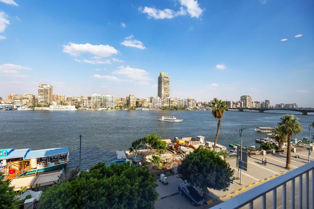 a view of a river with a city in the background at The Nile Residence in Cairo