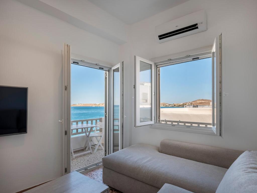 a living room with a couch and a view of the ocean at Paroikia Sunset in Kampos Paros