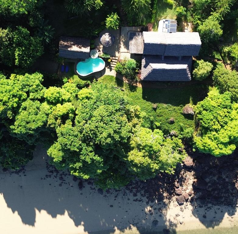 an aerial view of a garden with trees and a building at Ecolodge Nosy Faly in Nosy Be
