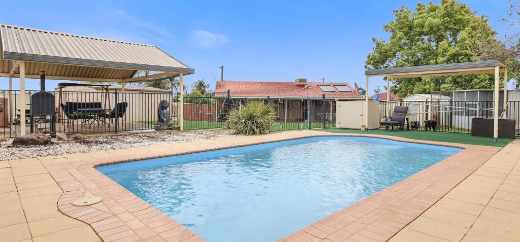 a swimming pool in a yard with a gazebo at Taking 5 in West Tamworth