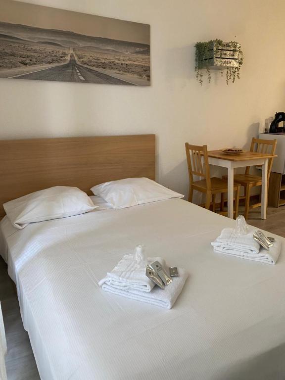 a bedroom with a white bed with towels on it at Fortezza in Bellinzona