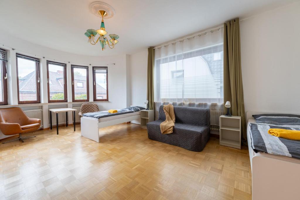 a living room with a bed and a chair at Space Comfort Bremen Apartment mit Balkon bis zu 6 Personen in Bremen