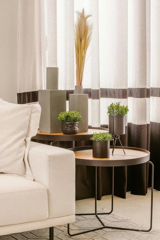 a living room with a table with potted plants on it at Tura campany ltd in Kigali