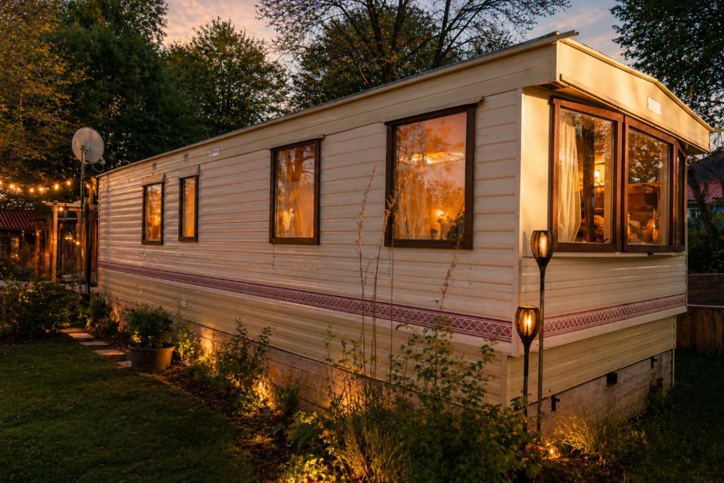 a tiny house with lights in a yard at Rustig Chalet Ardennen The Forest Haven in Amblève