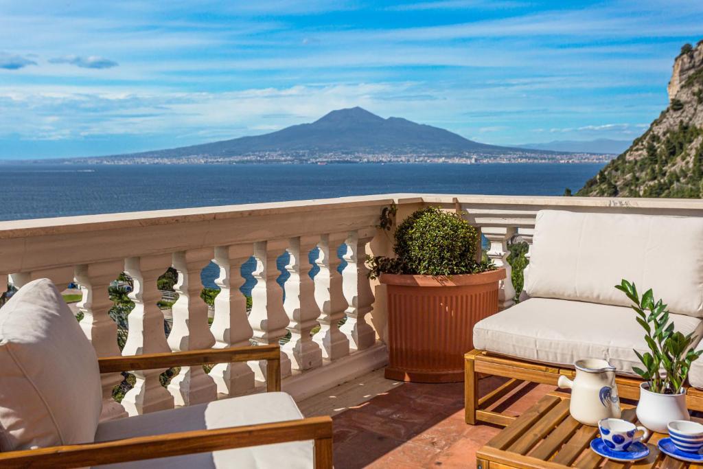 a balcony with chairs and a view of the ocean at Villa Margi in Vico Equense