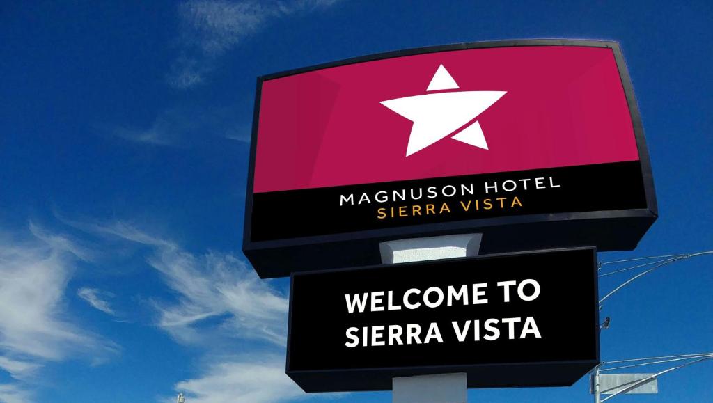 a sign for a masuvian hotel and a welcome to sierra visa at Magnuson Hotel Sierra Vista in Sierra Vista