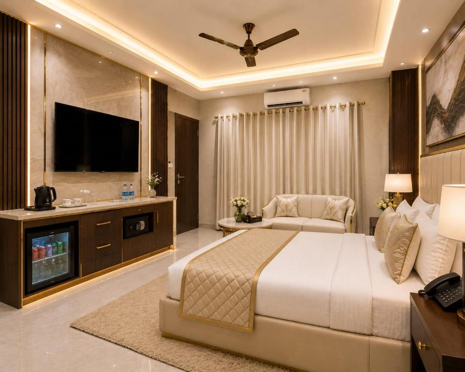 a bedroom with a bed and a flat screen tv at Hotel Grand Paul in New Delhi