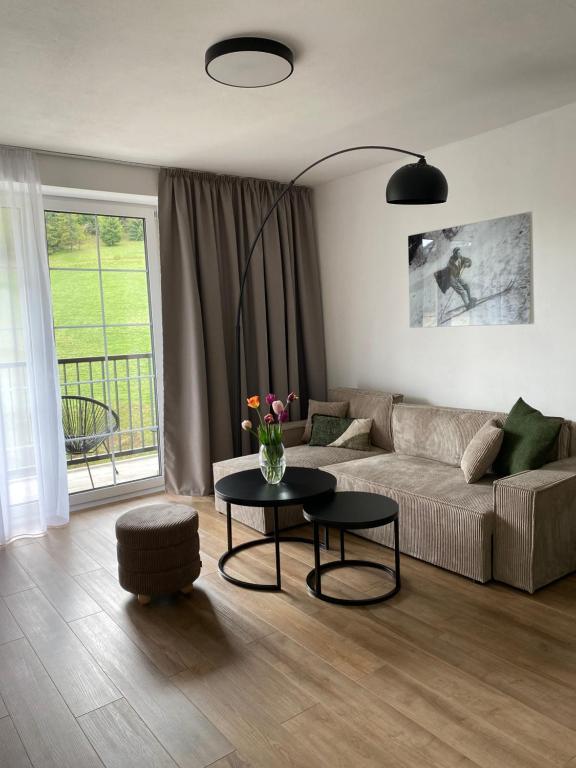a living room with a couch and a table at Apartmán KOZAK LITMAN in Litmanová