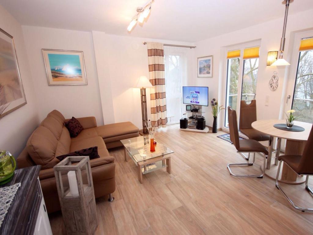 a living room with a couch and a table at Villa Amelie App Seestern in Sassnitz