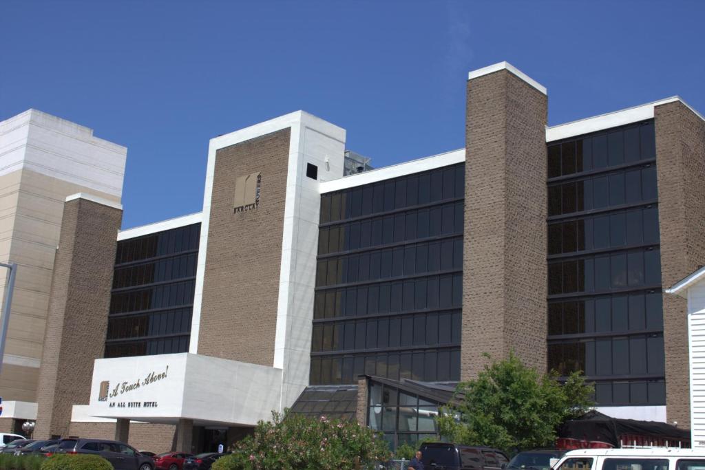 a building with a sign on the side of it at Barclay Towers Resort in Virginia Beach