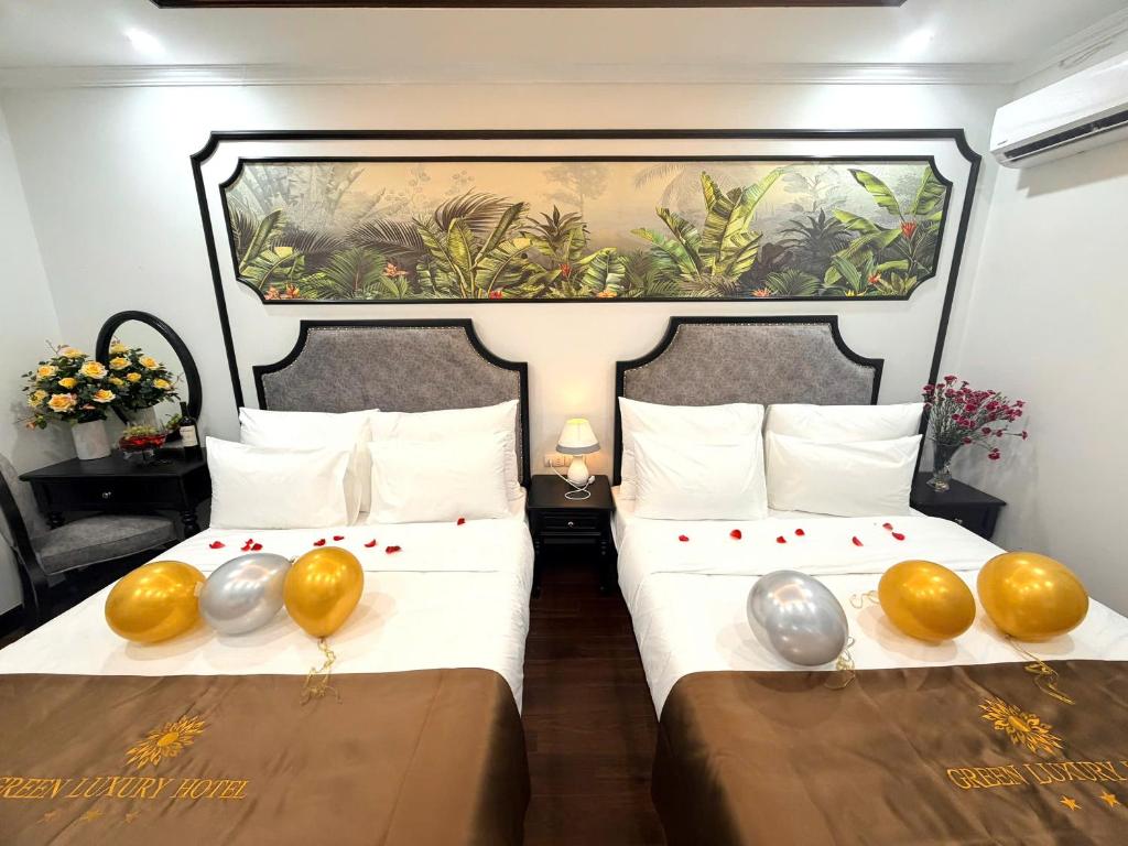 a bedroom with two beds with balloons on them at Green Luxury Hanoi Hotel in Hanoi