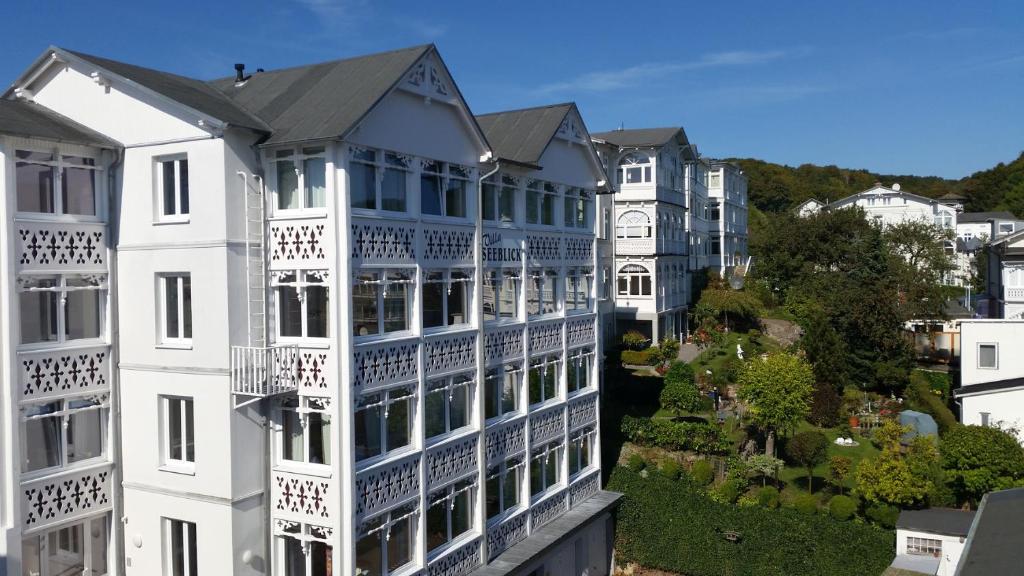 a white building with a clock on the side of it at Villa Seeblick - Apartment 309 in Sassnitz