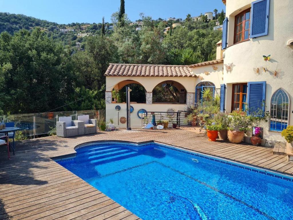 a villa with a swimming pool in front of a house at Casa Mimosa, Calonge Cabanyes in Calonge